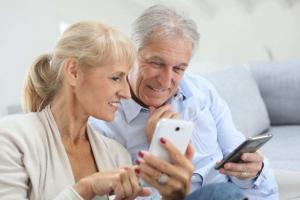 Senior couple enjoying their prepaid smartphones.